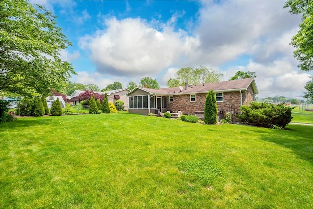 1116 Mcgovern Rd, Chartiers, PA 15342 - back of house featuring a sunroom, a lawn, and brick siding
