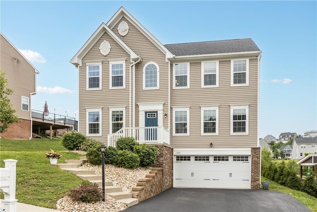 215 Saddle Ridge Dr, North Fayette, PA 15071 - view of front of house with asphalt driveway, a garage, a front lawn, and stairs