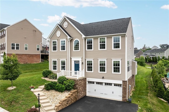 215 Saddle Ridge Dr, North Fayette, PA 15071 - view of front facade with asphalt driveway, an attached garage, and a front yard