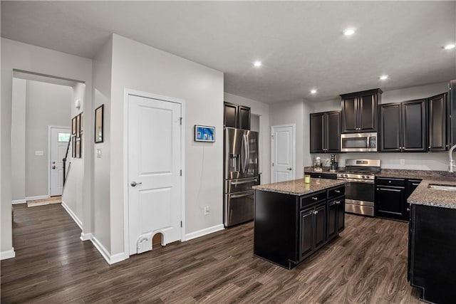 215 Saddle Ridge Dr, North Fayette, PA 15071 - kitchen with stainless steel appliances, a kitchen island, dark wood-type flooring, light stone counters, and recessed lighting
