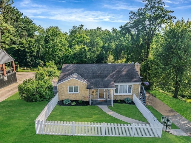 135 Taylor Run Rd, Carroll Twp, PA 15063 - bungalow with a fenced front yard, a chimney, and brick siding