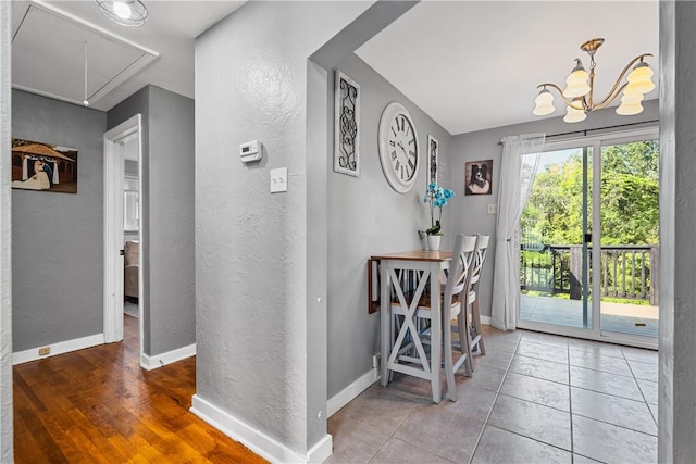 135 Taylor Run Rd, Carroll Twp, PA 15063 - tiled dining space with attic access, a textured wall, and a chandelier
