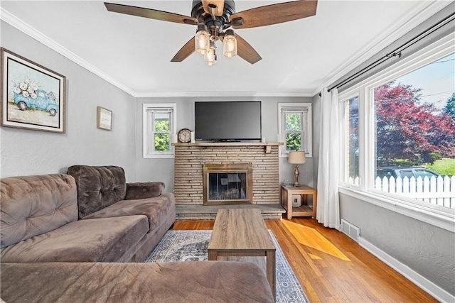 135 Taylor Run Rd, Carroll Twp, PA 15063 - living room featuring wood finished floors, ornamental molding, a ceiling fan, and a glass covered fireplace