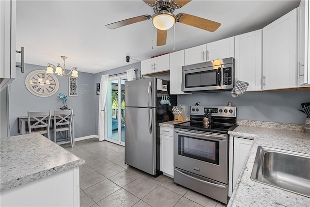 135 Taylor Run Rd, Carroll Twp, PA 15063 - kitchen with appliances with stainless steel finishes, light countertops, white cabinets, and light tile patterned flooring