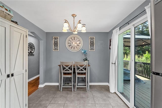 135 Taylor Run Rd, Carroll Twp, PA 15063 - dining room with arched walkways, a chandelier, and light tile patterned floors