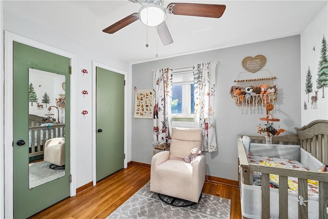 135 Taylor Run Rd, Carroll Twp, PA 15063 - bedroom featuring wood finished floors, a nursery area, and a ceiling fan