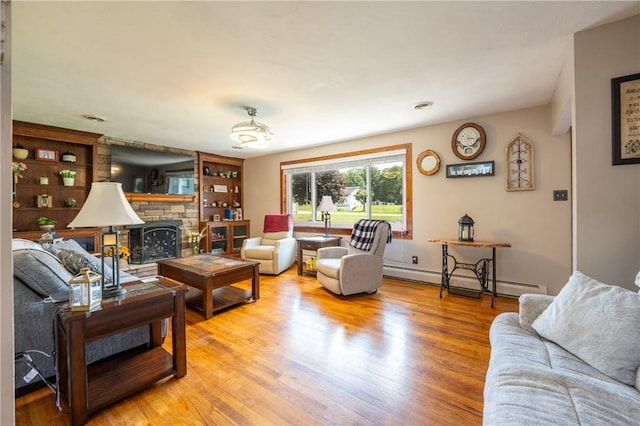 164 Seger Rd, Derry Twp, PA 15627 - living area with a baseboard heating unit, light wood-type flooring, a stone fireplace, and built in shelves