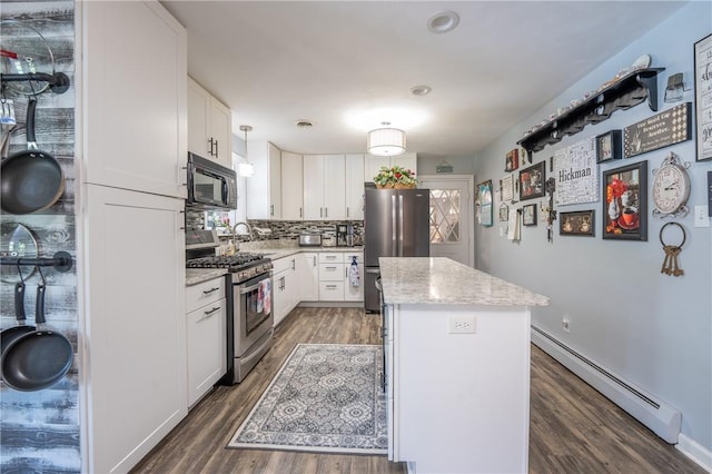 164 Seger Rd, Derry Twp, PA 15627 - kitchen with appliances with stainless steel finishes, a baseboard radiator, a kitchen island, and wood finished floors