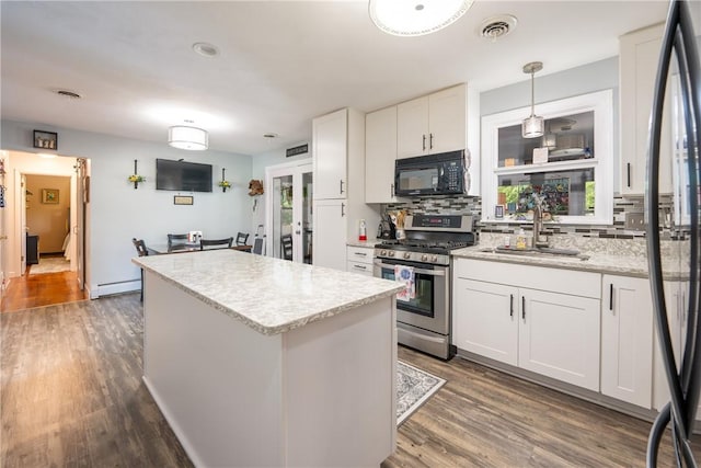164 Seger Rd, Derry Twp, PA 15627 - kitchen featuring gas stove, black microwave, tasteful backsplash, a center island, and french doors
