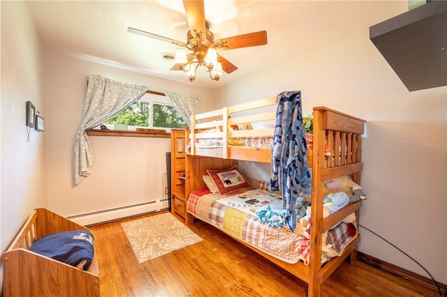 164 Seger Rd, Derry Twp, PA 15627 - bedroom featuring a baseboard heating unit, wood finished floors, and ceiling fan