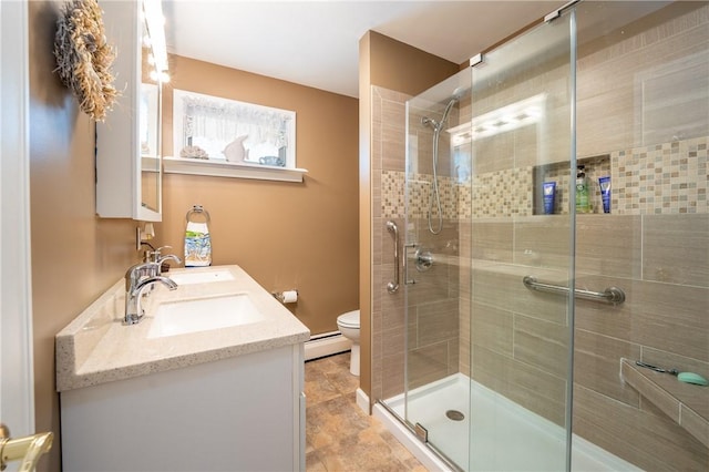 164 Seger Rd, Derry Twp, PA 15627 - bathroom with baseboard heating, a stall shower, and double vanity