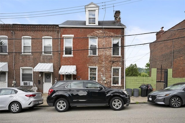 3520 Butler St, Lawrenceville, PA 15201 - view of property with brick siding, cooling unit, and a chimney