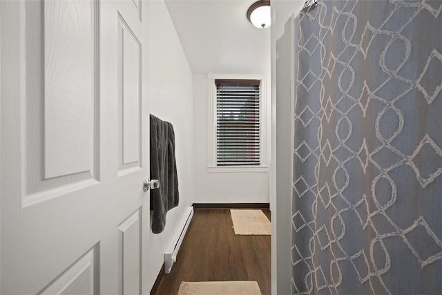3520 Butler St, Lawrenceville, PA 15201 - full bathroom featuring a baseboard heating unit, wood finished floors, and a shower with shower curtain