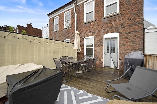 3520 Butler St, Lawrenceville, PA 15201 - back of house featuring brick siding, outdoor dining space, a wooden deck, and cooling unit