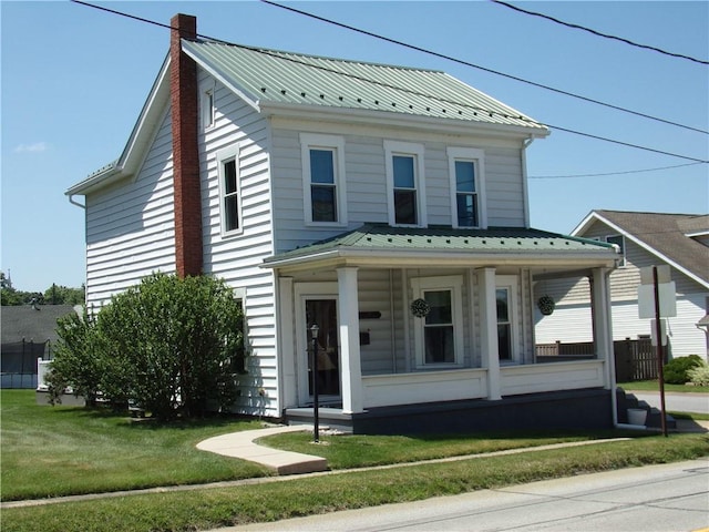 118 Cumberland St, Berlin, PA 15530 - view of front facade with a porch, a chimney, a metal roof, and a front lawn