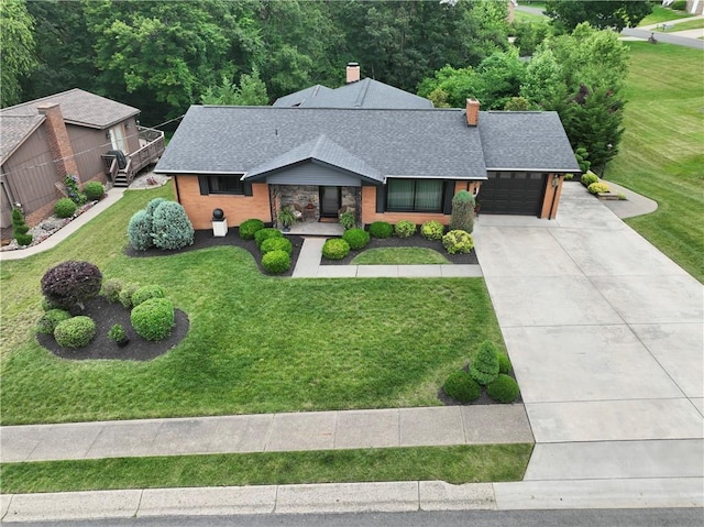 1402 Imperial Dr, Hopewell Twp Bea, PA 15001 - mid-century modern home with a shingled roof, an attached garage, a chimney, driveway, and a front yard