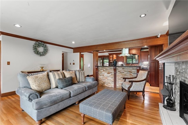 1402 Imperial Dr, Hopewell Twp Bea, PA 15001 - living room featuring ornamental molding, light wood finished floors, a fireplace with raised hearth, and recessed lighting