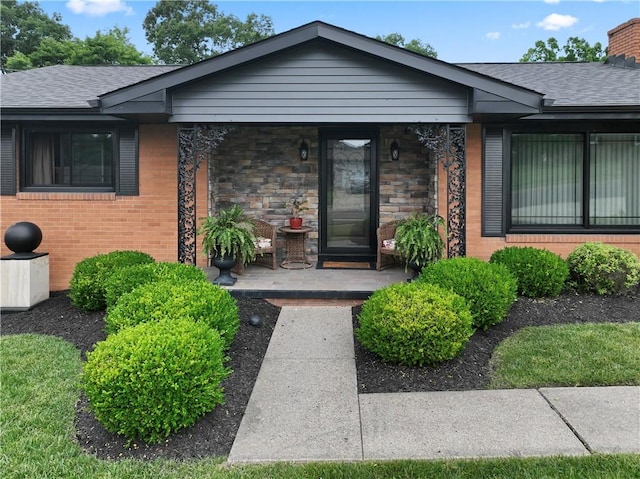 1402 Imperial Dr, Hopewell Twp Bea, PA 15001 - entrance to property with a shingled roof, brick siding, a chimney, and covered porch