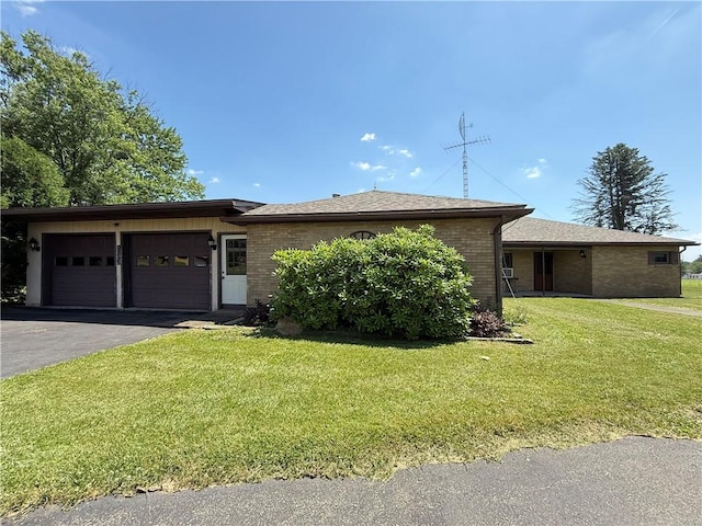 133 Hamburg Rd, Delaware Twp, PA 16154 - ranch-style house with a garage, brick siding, asphalt driveway, a front yard, and roof with shingles