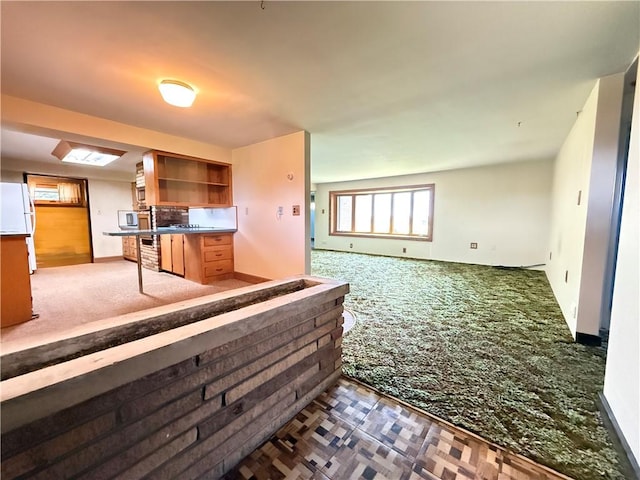 133 Hamburg Rd, Delaware Twp, PA 16154 - kitchen featuring carpet floors, open shelves, open floor plan, and freestanding refrigerator
