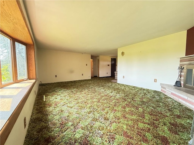 133 Hamburg Rd, Delaware Twp, PA 16154 - unfurnished living room with carpet floors and a glass covered fireplace