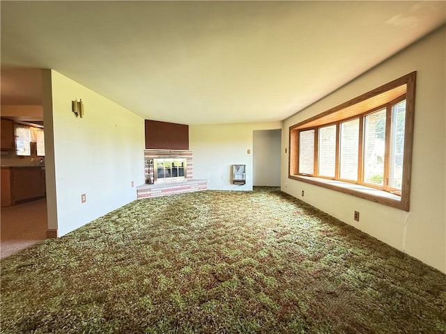 133 Hamburg Rd, Delaware Twp, PA 16154 - unfurnished living room featuring carpet, a brick fireplace, and heating unit