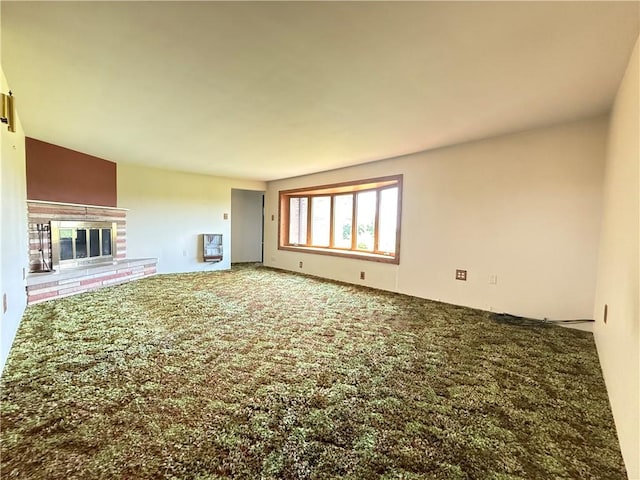133 Hamburg Rd, Delaware Twp, PA 16154 - unfurnished living room featuring carpet flooring, a fireplace, and heating unit