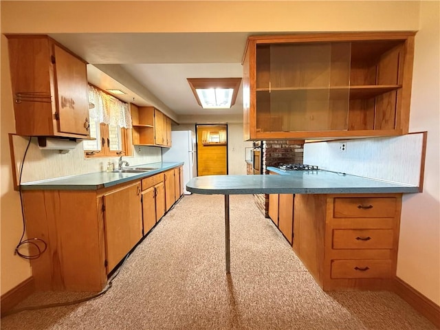 133 Hamburg Rd, Delaware Twp, PA 16154 - kitchen featuring open shelves, freestanding refrigerator, light carpet, and brown cabinets