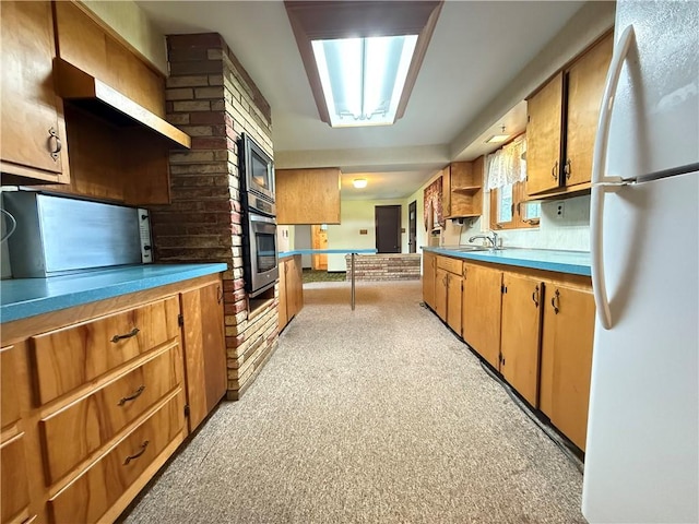 133 Hamburg Rd, Delaware Twp, PA 16154 - kitchen featuring freestanding refrigerator, stainless steel oven, open shelves, brown cabinets, and light countertops