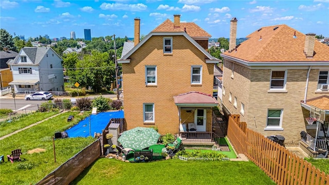 426 Saint Joseph St, Mount Oliver, PA 15210 - rear view of property with a fenced backyard, brick siding, and a chimney