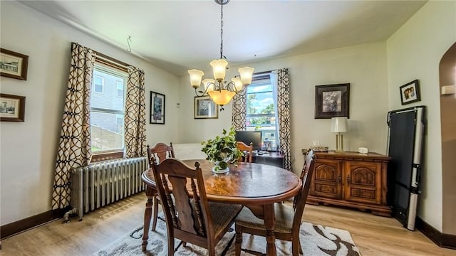 426 Saint Joseph St, Mount Oliver, PA 15210 - dining space with radiator heating unit, light wood finished floors, healthy amount of natural light, and a chandelier
