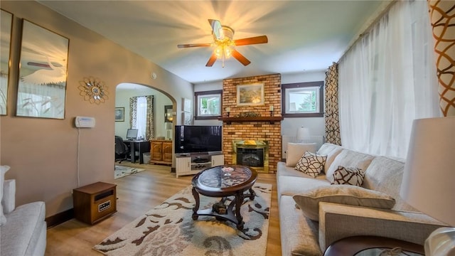 426 Saint Joseph St, Mount Oliver, PA 15210 - living room with ceiling fan, arched walkways, wood finished floors, and a brick fireplace