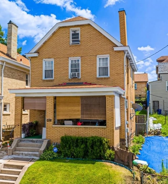 426 Saint Joseph St, Mount Oliver, PA 15210 - view of front of home with brick siding and a front yard