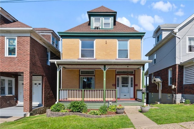 2303 Los Angeles Ave, Beechview, PA 15216 - american foursquare style home featuring a porch, brick siding, and a front yard