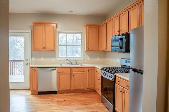 2426 Rochester Rd Unit C, Franklin Park, PA 15143 - kitchen featuring appliances with stainless steel finishes, light wood finished floors, light countertops, and light brown cabinetry