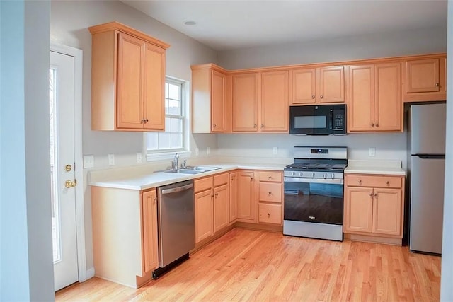 2426 Rochester Rd Unit C, Franklin Park, PA 15143 - kitchen with appliances with stainless steel finishes, light brown cabinetry, light wood-type flooring, and light countertops