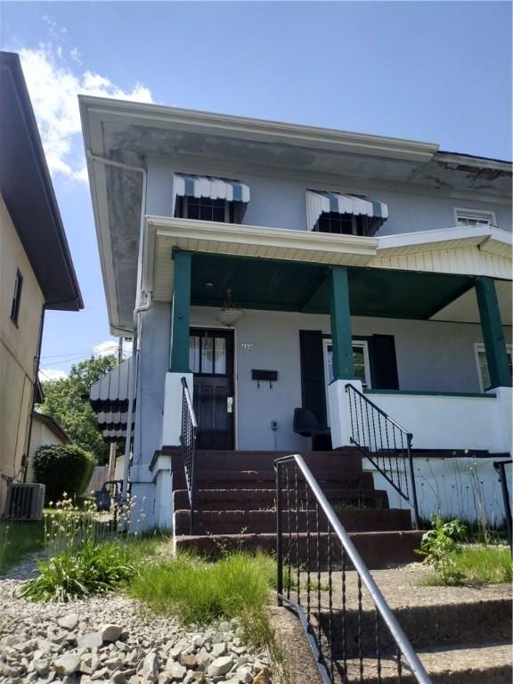 125 Bertha Ave, Donora, PA 15033 - view of front facade with a porch, stairway, and stucco siding