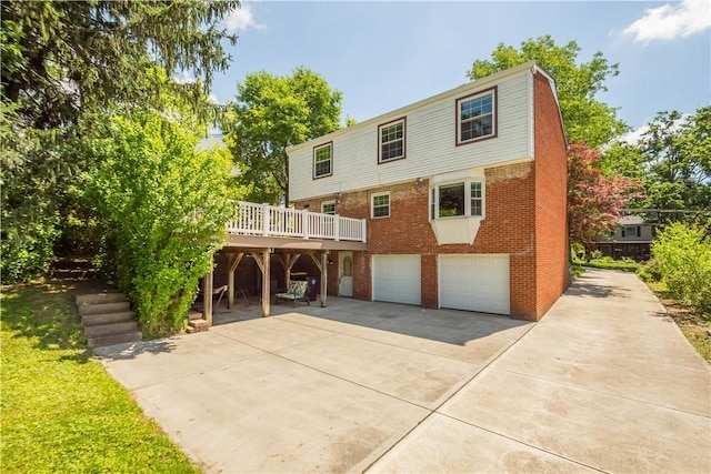 5934 Barnes Ave, Bethel Park, PA 15102 - back of property with driveway, a garage, brick siding, and a deck
