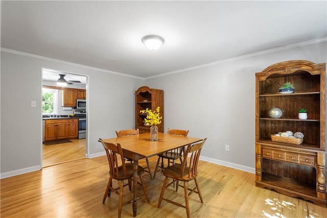 5934 Barnes Ave, Bethel Park, PA 15102 - dining room featuring light wood-style flooring, ornamental molding, and a ceiling fan