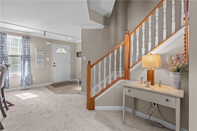 102 Castle View Dr, Kennedy Twp, PA 15136 - foyer entrance featuring rail lighting, carpet floors, ornamental molding, and stairway