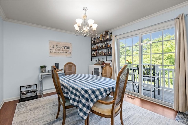 102 Castle View Dr, Kennedy Twp, PA 15136 - dining area with a chandelier, ornamental molding, wood finished floors, and a dry bar