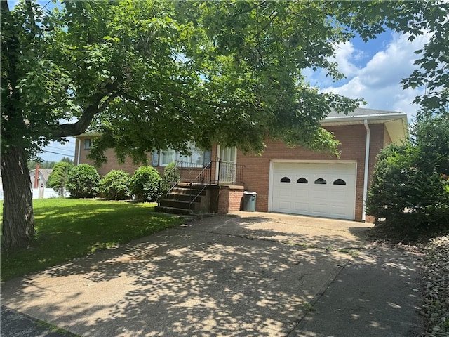 11 Edith St, Center Twp/Homer Cty, PA 15748 - view of property hidden behind natural elements with brick siding, concrete driveway, a front yard, and a garage