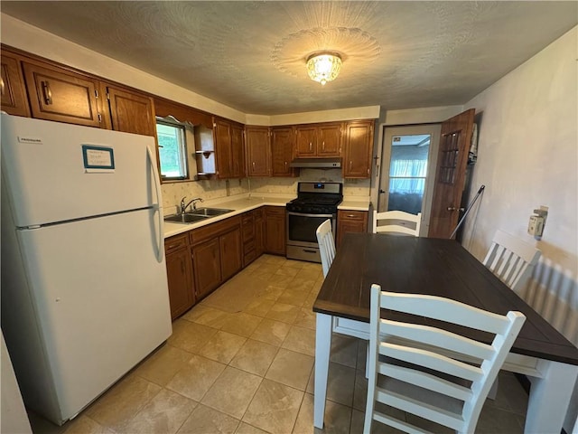11 Edith St, Center Twp/Homer Cty, PA 15748 - kitchen with freestanding refrigerator, stainless steel gas range, under cabinet range hood, and healthy amount of natural light