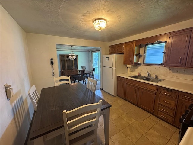 11 Edith St, Center Twp/Homer Cty, PA 15748 - kitchen featuring freestanding refrigerator, a chandelier, light countertops, and plenty of natural light