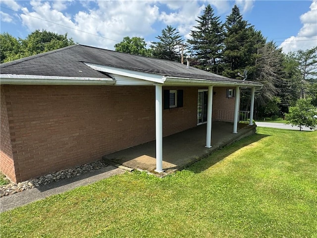 11 Edith St, Center Twp/Homer Cty, PA 15748 - view of property exterior featuring a yard, brick siding, a patio, and a shingled roof