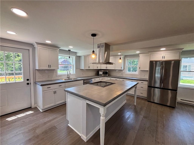 324 Hoover St, Saint Clair Twp, PA 15954 - kitchen with appliances with stainless steel finishes, island range hood, dark wood-style floors, healthy amount of natural light, and recessed lighting