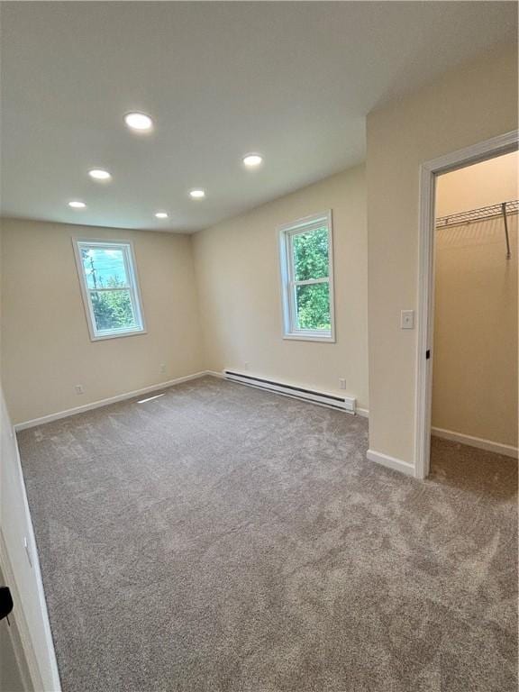 324 Hoover St, Saint Clair Twp, PA 15954 - unfurnished bedroom with a baseboard heating unit, carpet floors, multiple windows, recessed lighting, and a spacious closet