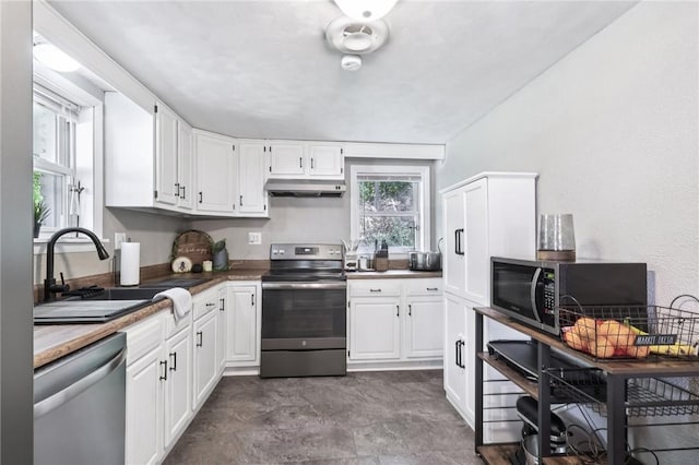 476 Trees Mills Rd, Salem Twp, PA 15601 - kitchen with stainless steel appliances, under cabinet range hood, and white cabinetry