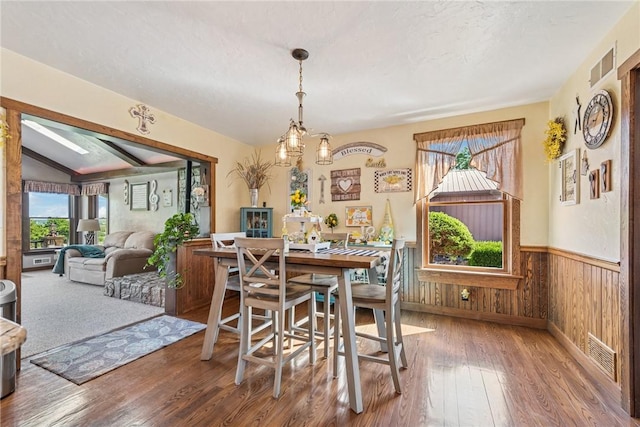 227 Holly Pl, Mount Pleasant Twp Wml, PA 15666 - dining room featuring hardwood / wood-style flooring, lofted ceiling, wood walls, and wainscoting