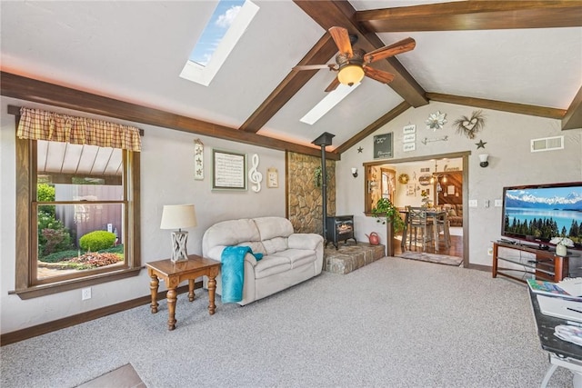 227 Holly Pl, Mount Pleasant Twp Wml, PA 15666 - living room featuring a wood stove, carpet, a skylight, and ceiling fan